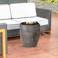 24-inch round Pentola II Bowl concrete fire pit table by Prism Hardscapes with lava rock burning display
