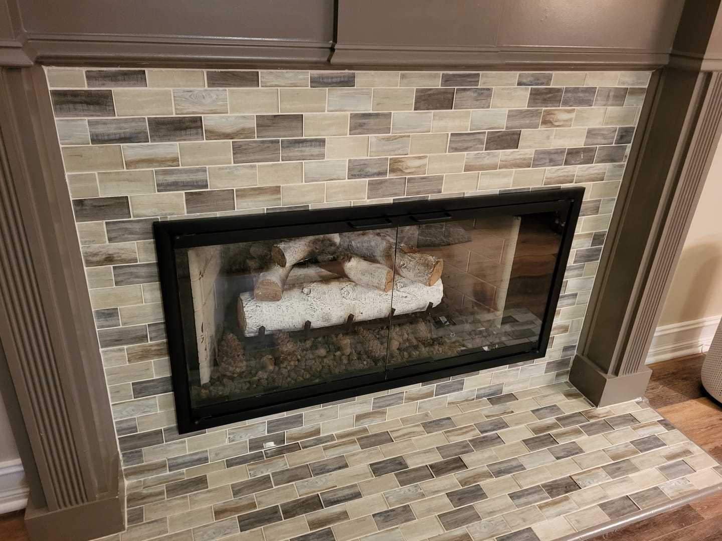 Rainbow Fireplace Glass Doors with aluminum frame and tempered safety glass installed in modern living room fireplace