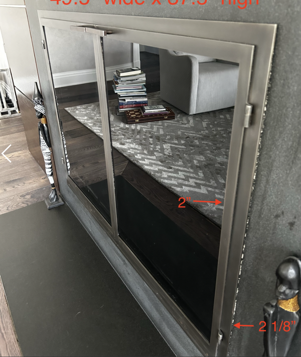 Carolina Fireplace Doors with natural iron frame, black glass, square handles, and center bar pattern