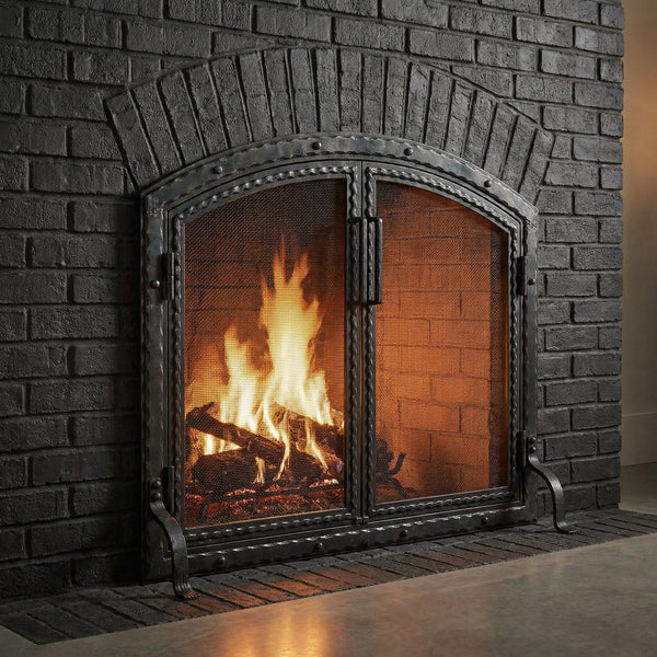Custom free standing fireplace screen with thick steel frame and arch working doors