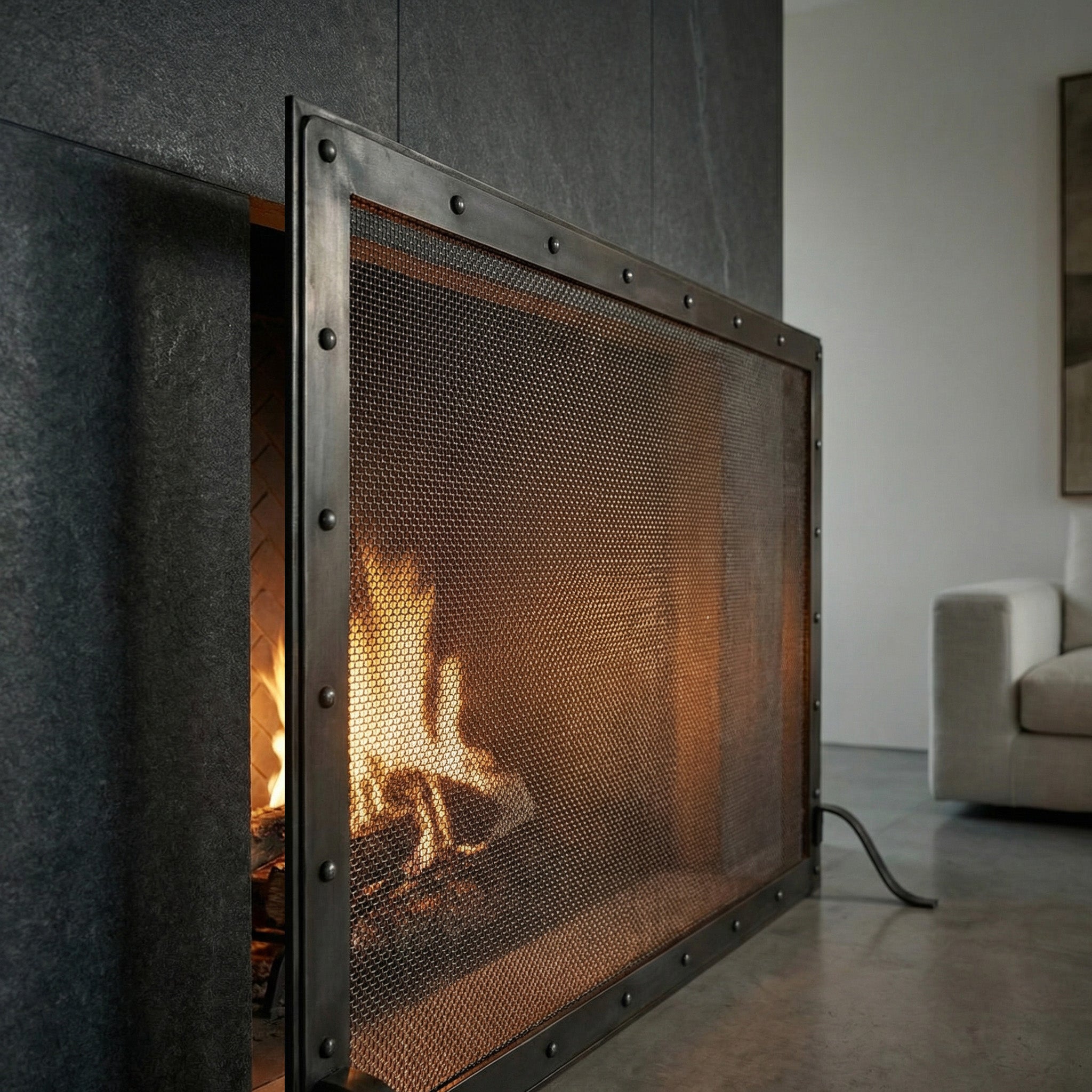 Custom made black steel fireplace screen with heavy gauge mesh and 9-inch foot depth