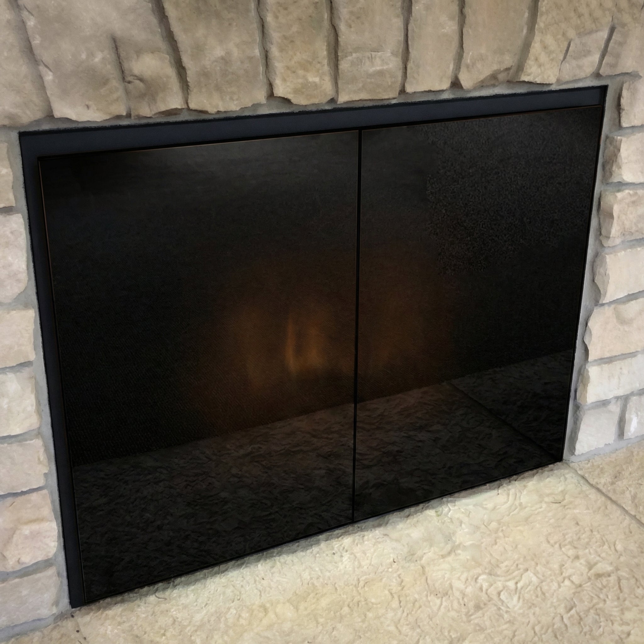 Odyssey Masonry & Prefab midnight black fireplace glass doors with flat black powder coat frame and twin handleless cabinet doors