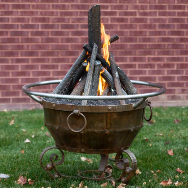 Round Mill Natural Gas Fire Pit 36-inch steel fire pit with rust patina and tee-pee stack logs