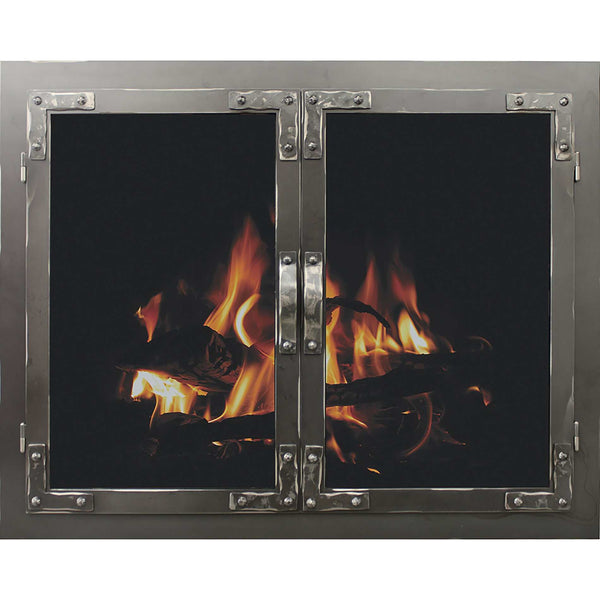 Rustic masonry fireplace glass door with distressed metal and riveted corners