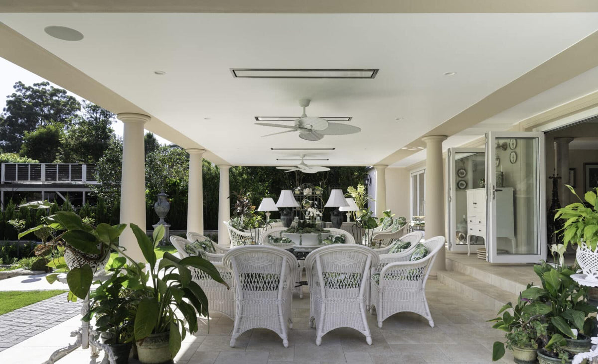 Recessed Bromic heaters following the length of an outdoor dining terrace