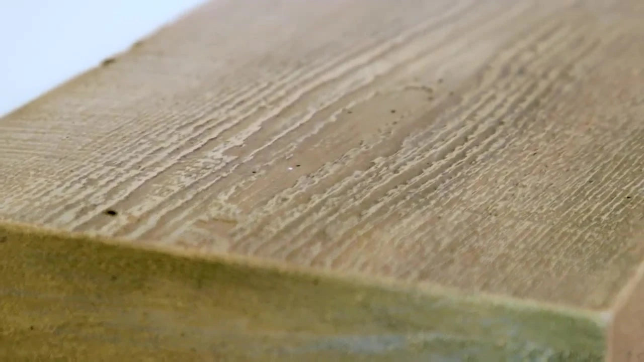 Close-up of the wood-grain texture and edge of a Flat Sawn concrete mantel.