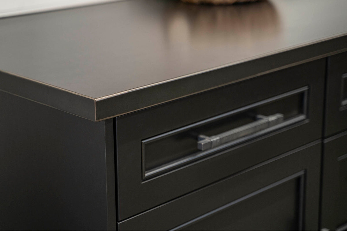 Close-up of a countertop edge and cabinetry from Due West